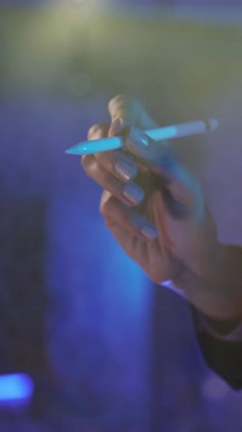 Hand Holding Stylus Pen on Blue Background