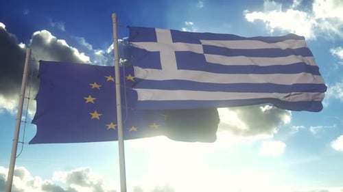 Greece and EU Flags Waving Against Blue Sky