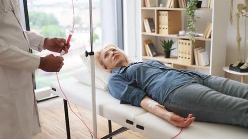 General Practitioner Checking Tubes Which Blood Flows of Female