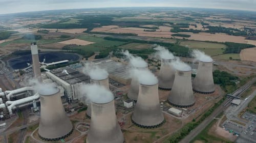 Wide descending establishing drone shot of Power station cooling towers