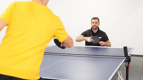 A Boy in a Wheelchair Plays Table Tennis