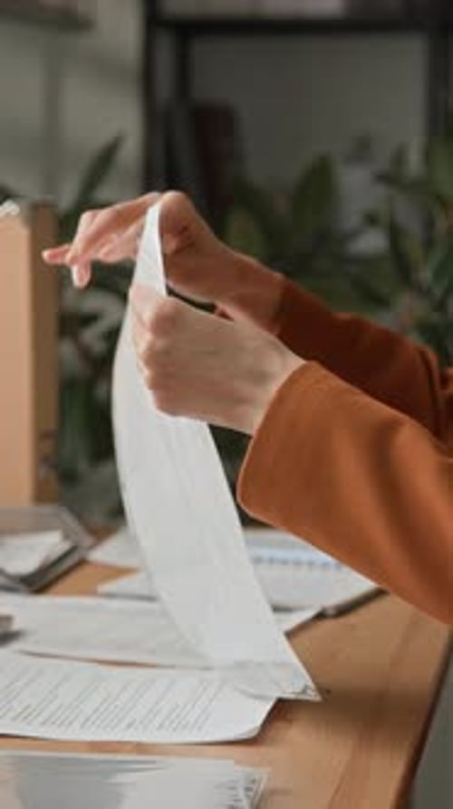 Office Worker Filing Documents at Desk