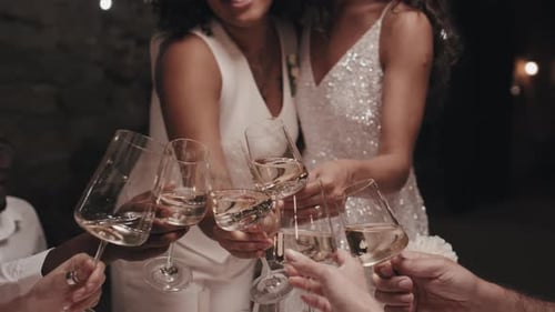 Brides Toasting at Night Wedding Celebration