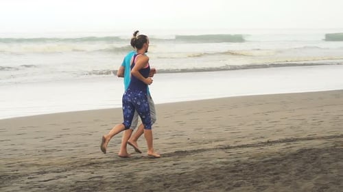 Sportive Couple Jogging On Beach, Super Slow Motion 120fps