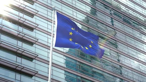 European Union Flag Waving at Modern Corporate Building