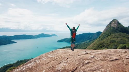 Adult Male Hiker Celebrates with Extended Hands on Top the Mountain in Brazil