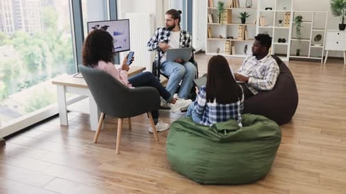 Diverse Group of Young Adults Collaborating in Casual Modern Office Setting