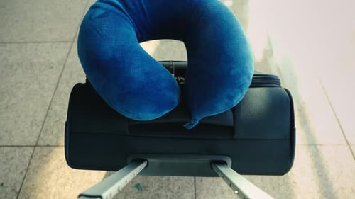 A Person Walking and Carrying a Suitcase in an Airport Terminal POV Shot Travel Concept