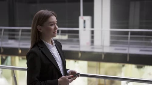 Successful Ambitious Young Woman Recruiter Walking in Workspace Office with Smartphone Going to