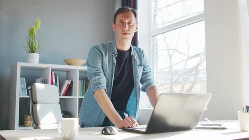 Young Male Entrepreneur Works at Home Office at the Computer Workplace of Freelancer or Student
