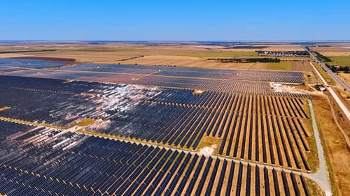 Aerial View of Solar Panel Farm on Sunny Day