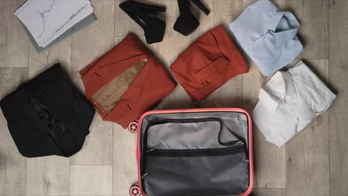 Stop Motion Animation Packing a Suitcase with Business Women's Clothes for a Business Trip