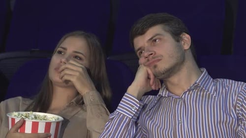 Bored Couple at the Cinema Lost in a Dull Movie