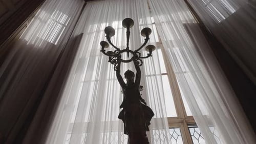 Ornate Room with Statue Holding Candelabra