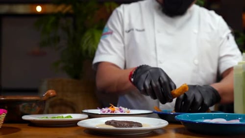 Chef putting fish fried for mexican taco recipe in restaurant