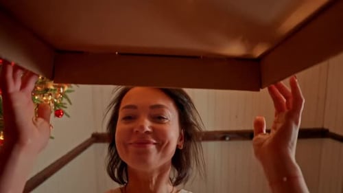 Smiling Woman Opening Christmas Box