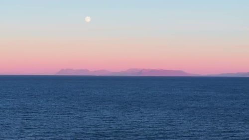 Flyover vast oceanscape, serene seascape with mountain silhousette in the background