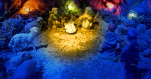Christmas Nativity Scene with hand-coloured figures, close up of the holy family in a cave.
