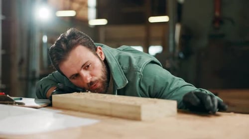 Carpentry, woodwork and man in factory with dust on wood for furniture, manufacturing