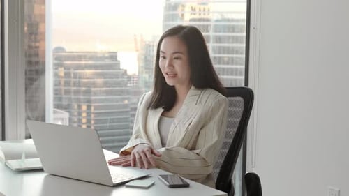 Young Woman in Office on Video Conference