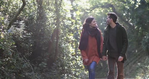Couple walking in forest in Fall