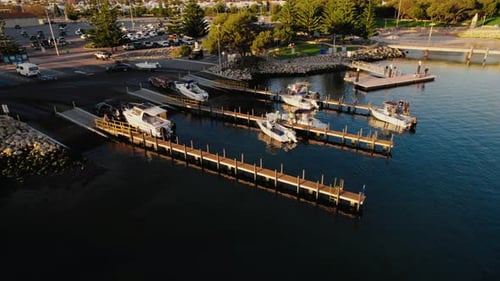 Adults loading boats at marina on sunny daytime