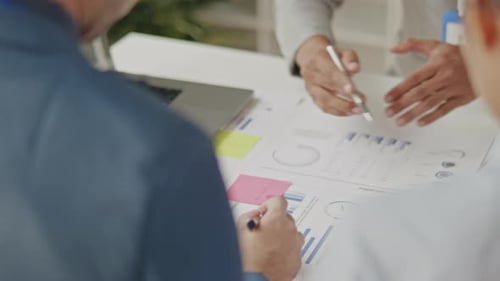 Close up of business hands are working and brainstorming on paperworks.