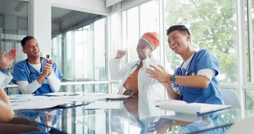 Medical Professionals Celebrating Achievement in Bright Office