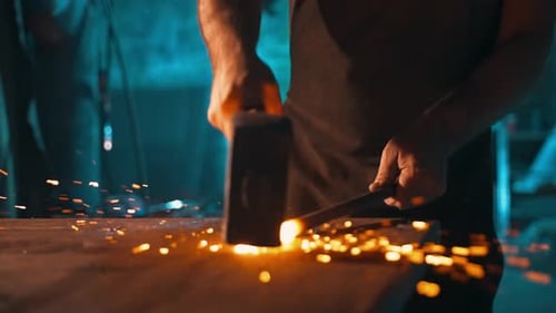 Blacksmith Forging Metal With Hammer on Anvil