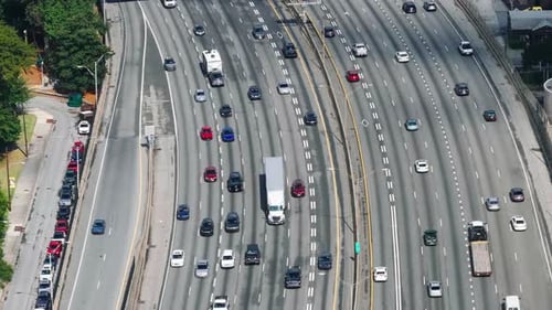 High angle view of cars driving on wide highway. Various color vehicles on busy thoroughfare. Atlant