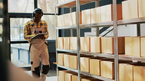 Warehouse Workers Inspect Inventory and Discuss Shipment