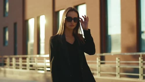 Close Up Professional Woman with Sunglasses Walking in Suit Near Building Entrepreneur Confident