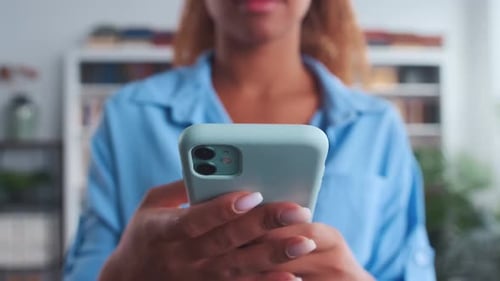 Woman Using Smartphone Indoors Close Up