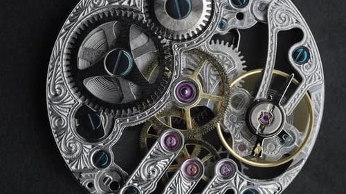 Silver Chain and Internal Working Mechanism of an Antique Pocket Watch on a Gray Background Screws