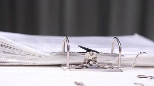 Closeup Office Worker Placing Documents Binder Folder in Lever Arch File