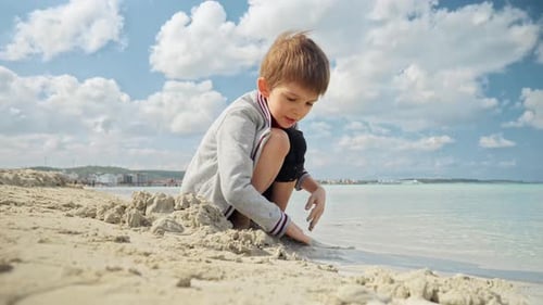 A happy boy plays on a beautiful beach, childhood joy and exploration