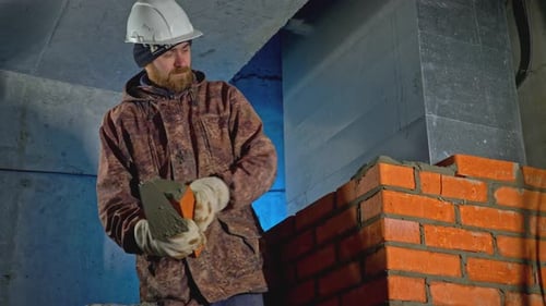 Man Building Brick Wall Under Construction