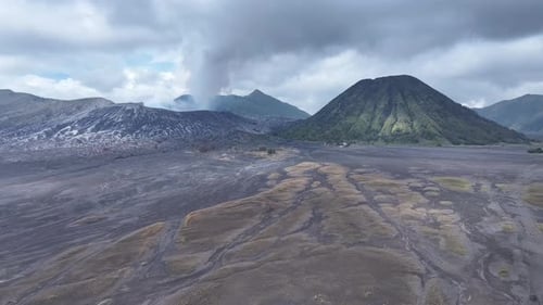 aerial view flying to mount Bromo active volcano above sea of clouds, Java, Indonesia