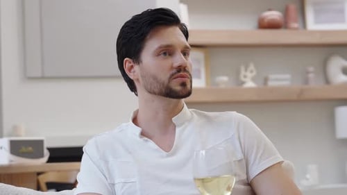 Man Relaxing on Couch with Glass of Wine