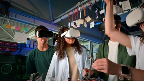 Group of young people in VR glasses discussing and doing experiments in robotics in a laboratory. Ro