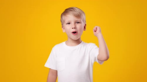 Happy Young Boy with an Idea on Yellow