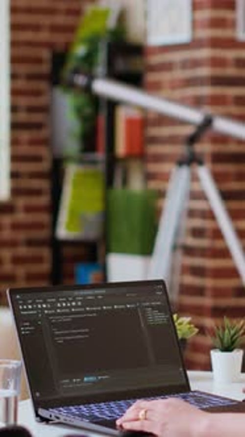 Vertical Video Asian Freelancer Woman Works on Programming Code in a Modern Office