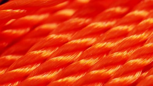 Orange rope close-up. Texture of braided rope. Orange background.