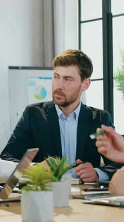 Man in Suit at Table in Office