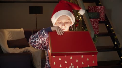 Child Opening Christmas Gift in a Red Box