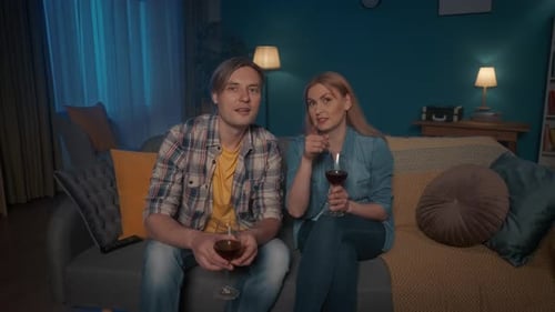 Couple Watching TV With Wine At Night