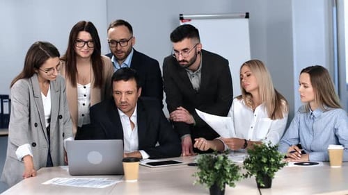 Team Discussing Project Around Conference Table