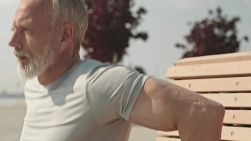 Senior Man Doing Bench Dips in the Park