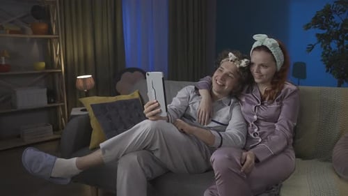 Couple in Pajamas Video Chatting at Home