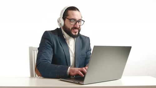Bearded Man in Suit Working at Laptop